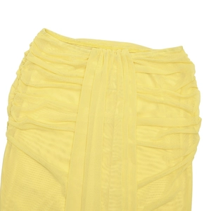 Detailed view of yellow mesh skirt texture and pleated fabric design on the mini skirt