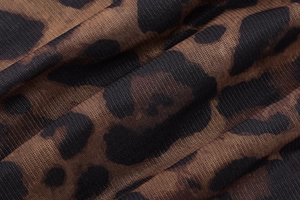 Macro shot of breathable leopard print mesh fabric with brown and black patterns