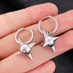 Close-up of punk style silver spiked ball earrings with metallic finish for men and women