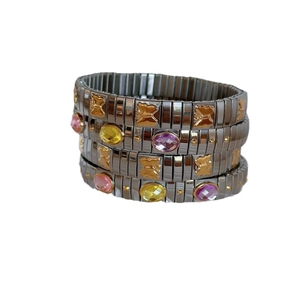 Set of four stacked stainless steel stretch bracelets with butterfly charms and colorful gems