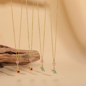 Detail of bear and rabbit gold necklaces with colorful zircon heart and star pendants