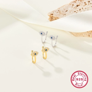 Detail of gold and silver S925 sterling silver evil eye nose clips with blue stones