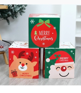 Three stacked Christmas gift boxes with Santa and reindeer designs in home setting