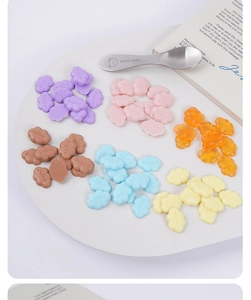 Close-up of 2cm colorful resin clouds with Ange-e relief for DIY slime and crafts