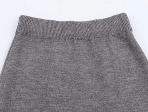 Close-up of the ribbed elastic waistband on gray knitted skirt showing premium texture