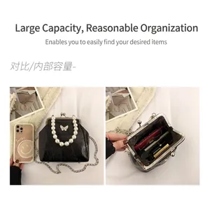 Retro black pearl handle crossbody bag with bow detail and metal chain strap
