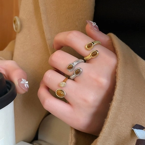 Detail of vintage crossover rings with oval tiger eye stone in a lifestyle setting
