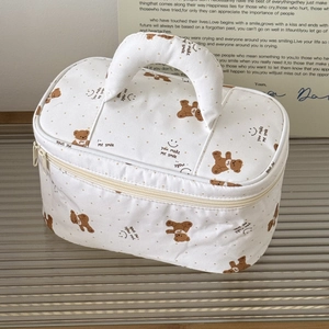 Detail of dachshund printed makeup bag with bear patterns and dual zipper closure