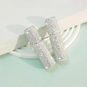 Macro shot of sparkling rhinestone-encrusted 10ml travel perfume spray bottles