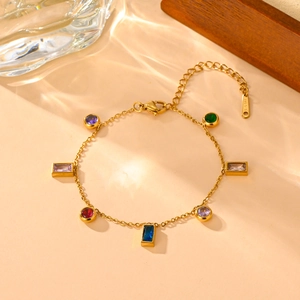 Elegant gold titanium steel bracelet with colorful zircon stones on a refined background