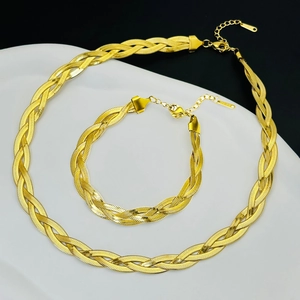 Close-up of gold-plated flat snake bone chain jewelry set with necklace and bracelet
