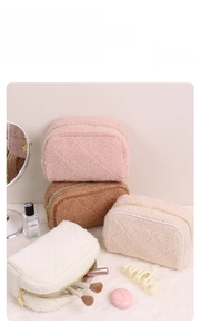 Close-up of quilted teddy fleece cosmetic bags with golden star zipper pullers