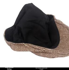 Detail of wool blend herringbone fabric and soft cotton lining on newsboy cap