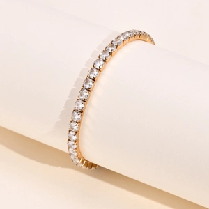 Close-up of gold stainless steel tennis bracelet with sparkling clear cubic zirconia stones