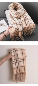 Detail of checkered plaid scarf with fringe tassels, beige cashmere-like woven fabric