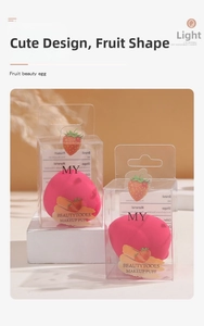 Detailed close-up of strawberry-shaped beauty sponge in elegant orange studio setting
