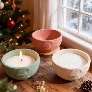 Embossed Santa Claus resin candle cups with white wax granules in festive holiday setting