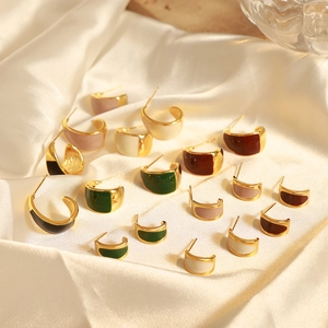 Elegant British vintage enamel crescent earrings in assorted colors on silk fabric