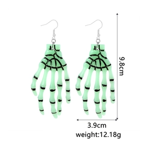 Detailed view of neon green skull hand earrings with size markings 9.8cm by 3.9cm