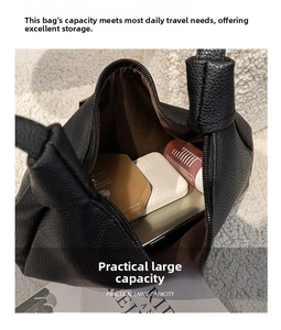 Top-down close-up showing large storage capacity of black pebble leather shoulder bag
