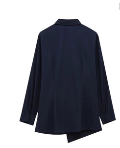 Detail of navy blue poplin shirt featuring long sleeves and an asymmetrical hemline cut