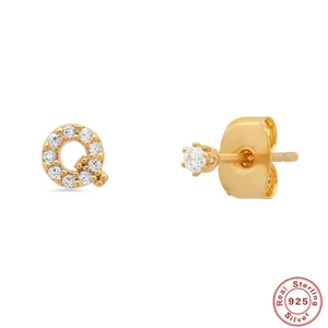 Macro view of gold S925 sterling silver letter Q stud earring set with cubic zirconia