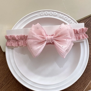 Pink elastic infant headband featuring a large layered tulle bow with gold polka dots