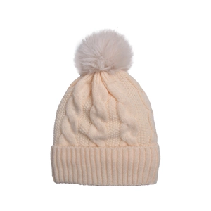 Detail of beige cable knit beanie featuring a soft faux fur pompom and ribbed cuff