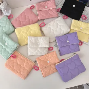 Close-up of heart-quilted candy color storage bags with zipper and snap button details
