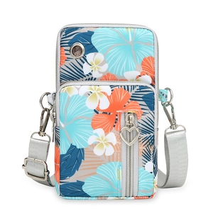 Vertical floral oxford cloth crossbody phone bag with adjustable grey strap and earphone port
