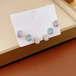 Three pairs of elegant oval zircon stud earrings in purple, blue and white silver settings