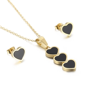 Elegant gold-tone jewelry set with black heart shell earrings and matching necklace