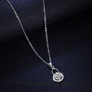 Elegant silver teardrop pendant necklace with sparkling central cubic zirconia and halo diamonds