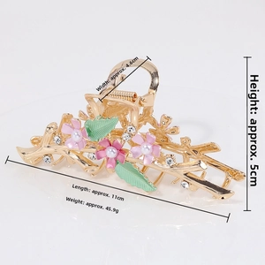 Detail view of large alloy flower hair claw with pink petals and pearls, size 11cm