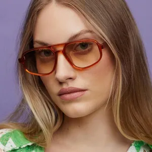 Pilot irregular sunglasses with orange-brown transparent frames and metal hinges