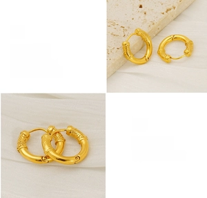 Detailed macro view of vintage gold hoop earrings with intricate cloud pattern engraving