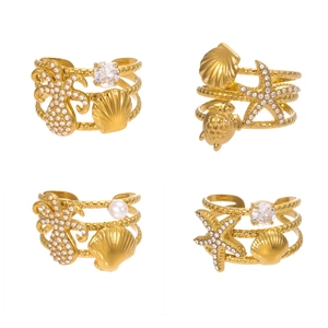 Gold ocean themed open bangles with starfish shell and zircon charms on white background
