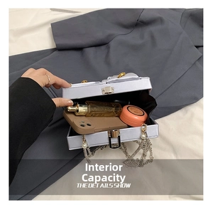Silver satin evening clutch interior showing capacity for phone and cosmetics