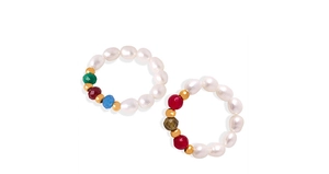 Detail of handcrafted rings with white natural pearls and colorful beaded accents