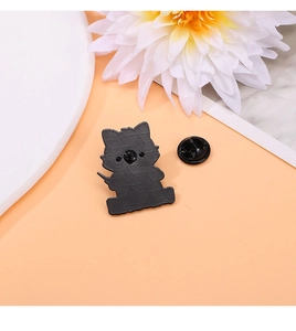 Detail view of the black enamel animal brooch back with secure butterfly pin fastener