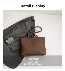 Detail of a brown leather tote bag showing the front pocket with snap button closure