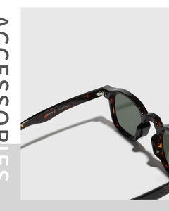 Close-up of tortoise shell frame hinges and printed size specifications on sunglasses temple
