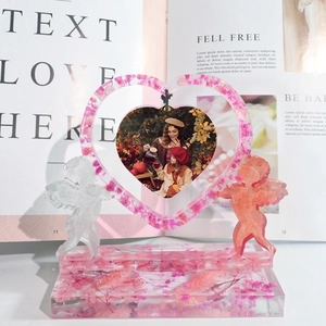 Detailed resin heart photo frame with pink dried flowers and angel sculptures