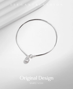 Macro shot of an elegant S925 sterling silver snake chain bracelet with a sparkling diamond