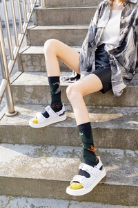 Street style dark green tiger pattern mid-calf socks paired with platform sandals