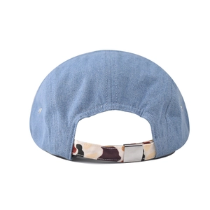 Detail of light blue denim hat back with camouflage adjustable strap and metal buckle