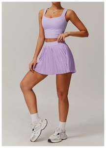 Detailed view of lavender athletic set featuring pleated tennis skirt and slim tank top