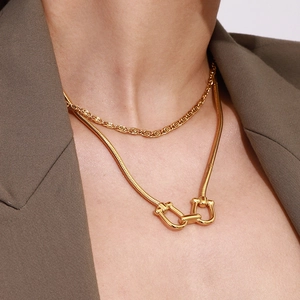 Double layered gold titanium steel necklace featuring a snake chain with interlocking U-buckle