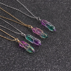 Macro detail of multi-colored hexagonal crystal pendants with gold and silver wire wrap