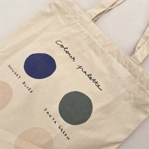 Detail view of cotton canvas tote bag featuring color palette prints and minimalist design